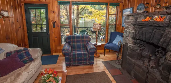 A plaid chair in front of a huge window