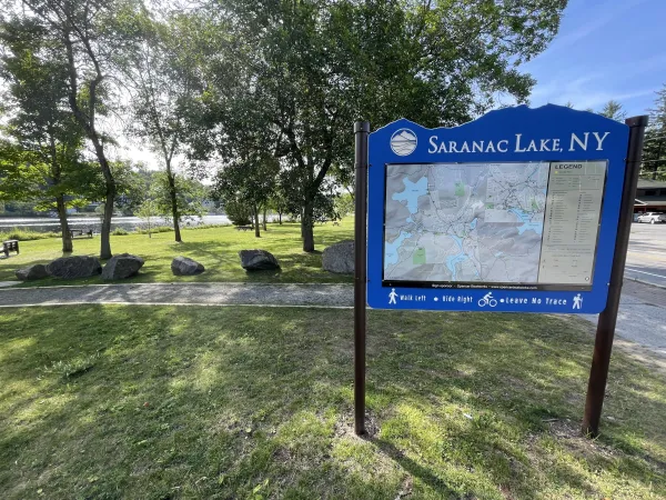 A sign of Saranac Lake in the park