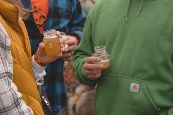 Close up of a couple drinking beer samples at OkTupperfest