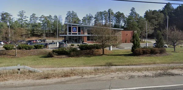 The exterior of Aldi shop and parking lot.