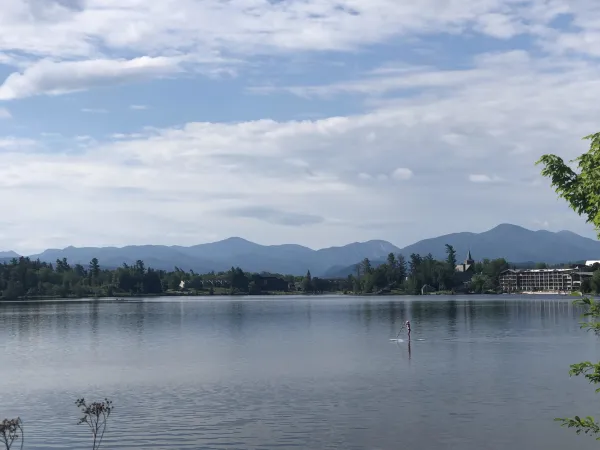 Mirror Lake with pine trees and tall mountains in the distance.