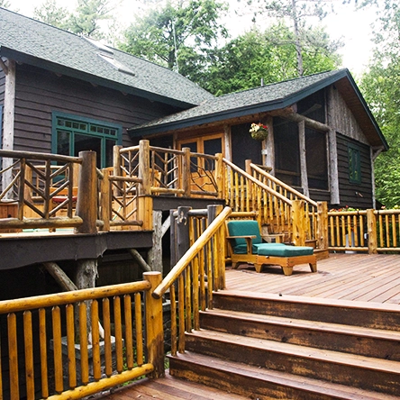 A brown cabin with large decks