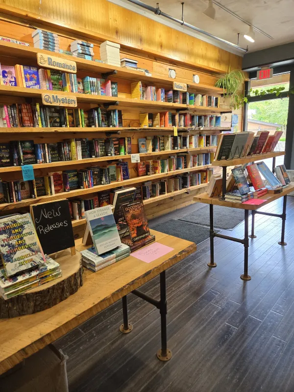 Walls and tables lined with Romance, Mystery, Fiction and Newly Released Books