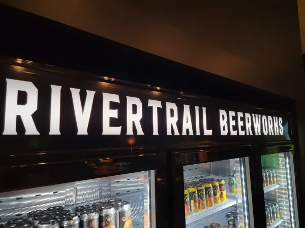 Cooler filled with canned Rivertrail Beerworks options.