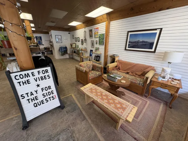 An open space with art on the walls, and a comfy seating area