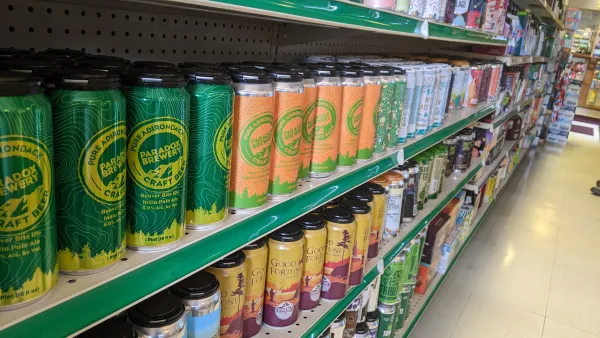 Cans of beer on a shelf.