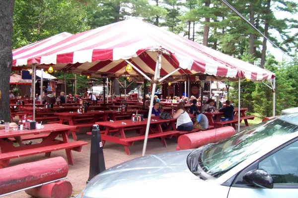 Red and white stripped   tent over red picnics