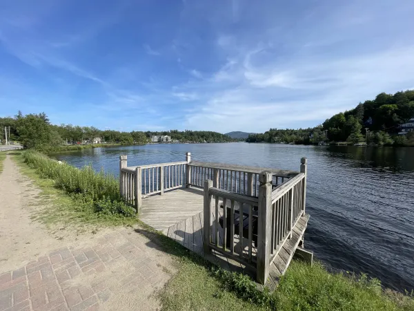 A small deck on the side of a pond