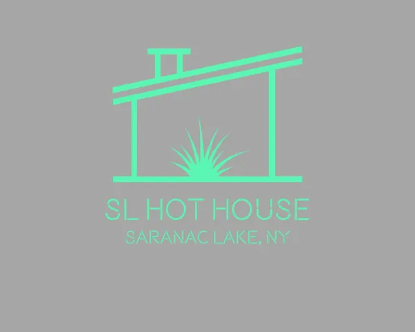 A gray image with a green lean to style structure with chimney and a grassy textured plant.