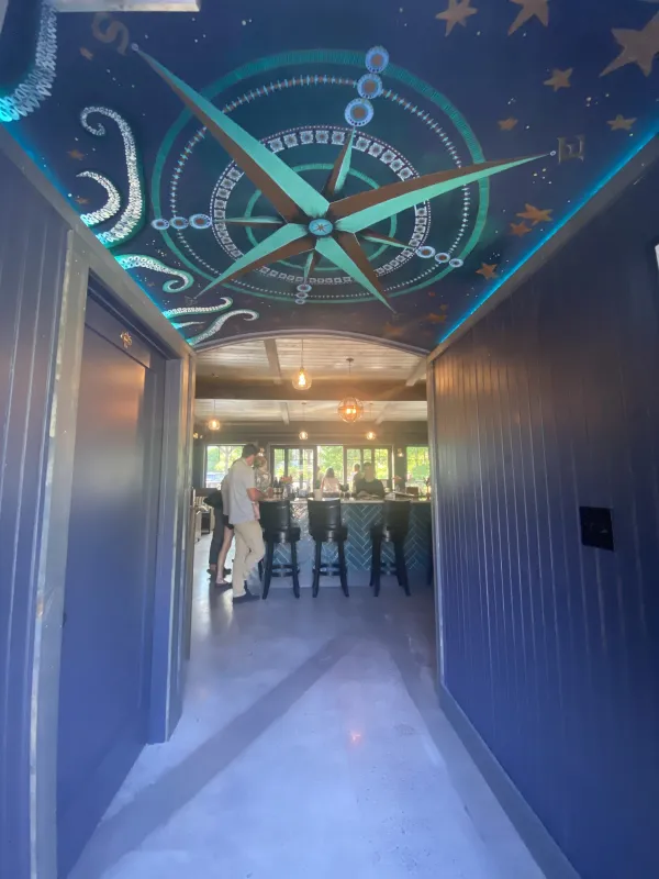 Entry way with ceiling mural of a cardinal directions compass