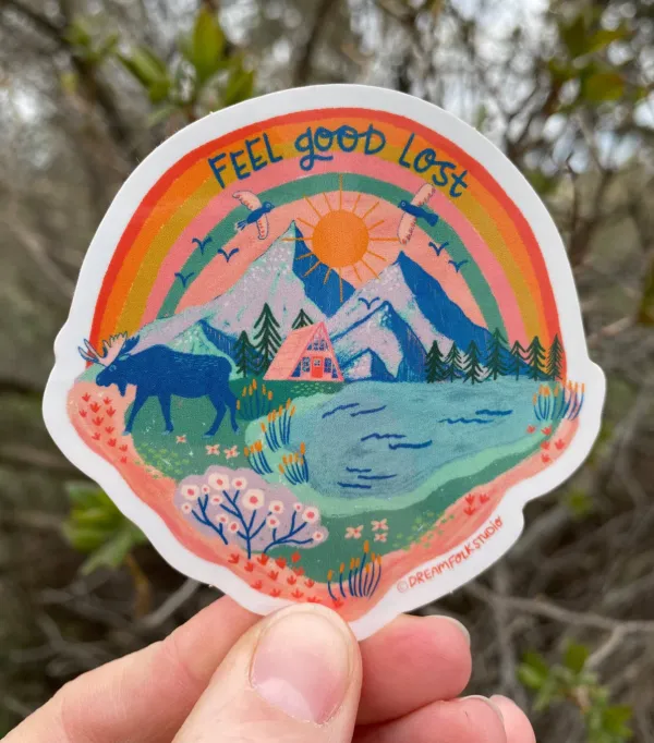 A sticker featuring a very colorful interpretation of the adirondacks with mountains, lakes, trees, moose, wild flowers, flying birds and a the perfect tent site.