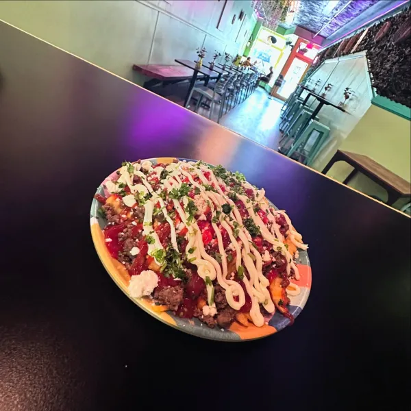 YAROA DOMINICANA  from Our Plates - 
Fries topped with Dominican ground beef, cheddar cheese, queso fresco, ketchup, and mayo