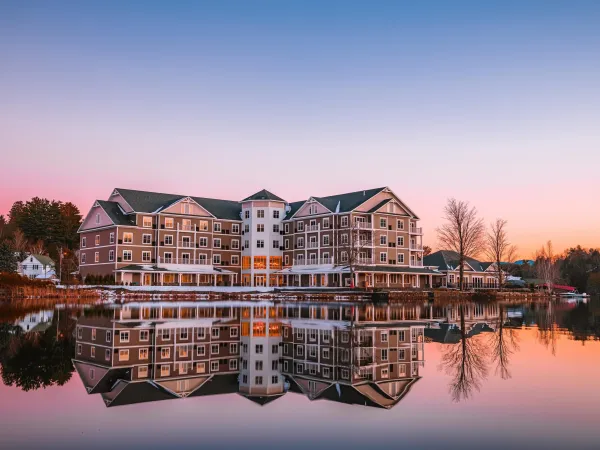 The exterior reflects off Lake Flower in a pink sunset