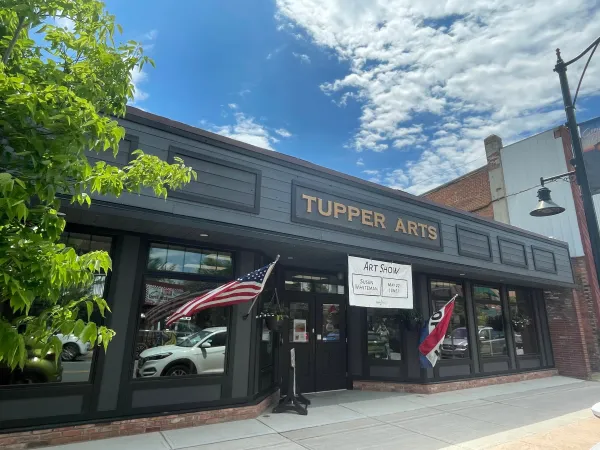 The exterior of Tupper Arts with blue skies and fluffy clouds above.