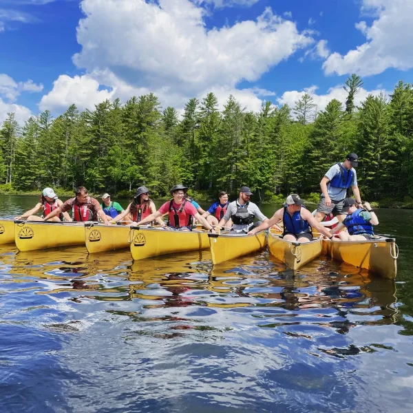 A group of paddlers lined up on the water.