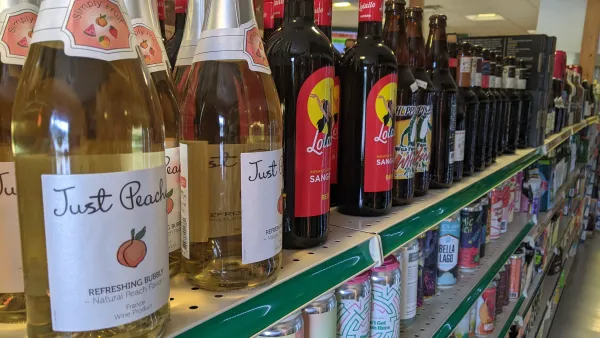 Wine and beer on a shelf.