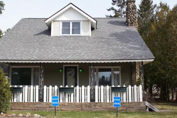 The house from the front with white picket fence at The Ashley.
