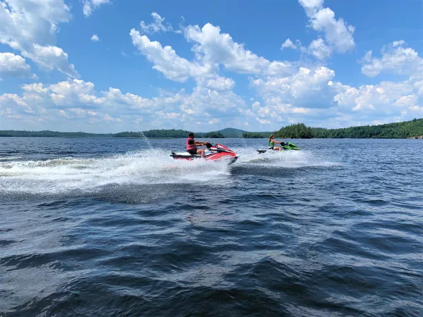 Jet Skiers ride through the water.