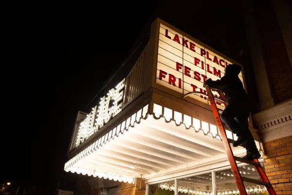 Image of a person updating the sign outside of the Palace Theatre