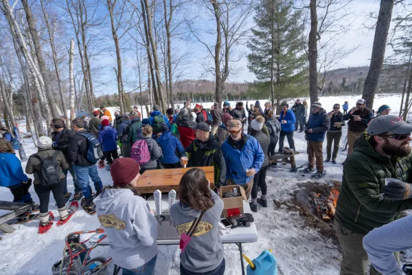 Cross-country skiers getting beer along a trail. 