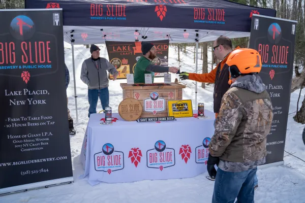 Snowshoers getting Big Slide Brewery beer. 