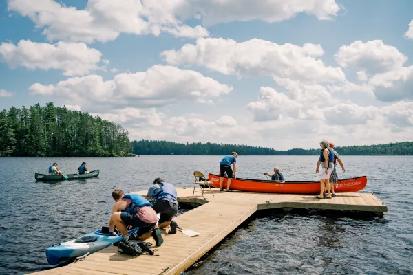 multiple canoes in mountain lake setting 