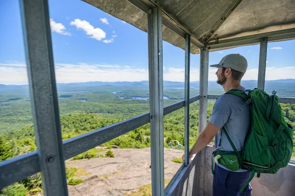 A hiker standing in the St Regis firetower