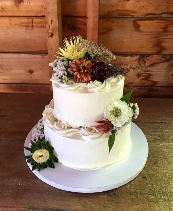 A two tiered cake with autumnal flowers 