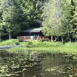 A waterfront log cabin.