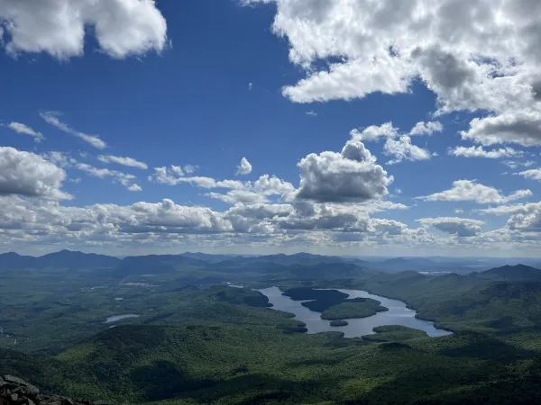 Lake Placid shimmers under puffy white clouds