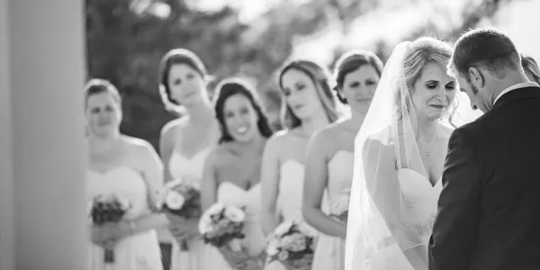 Bridesmaids look on at their friend.