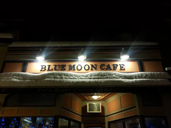 Nighttime view of the exterior of the Blue Moon Cafe in Saranac Lake