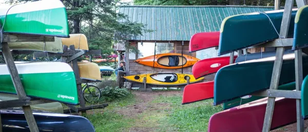 Colorful boats on racks outside.