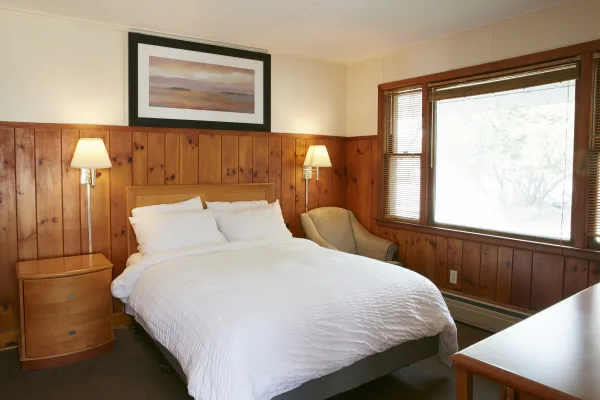 Plush white linens on a king bed at The Ashley.