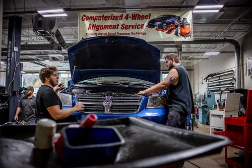 Students work on cars