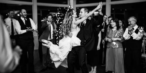 Groom twirls his bride.