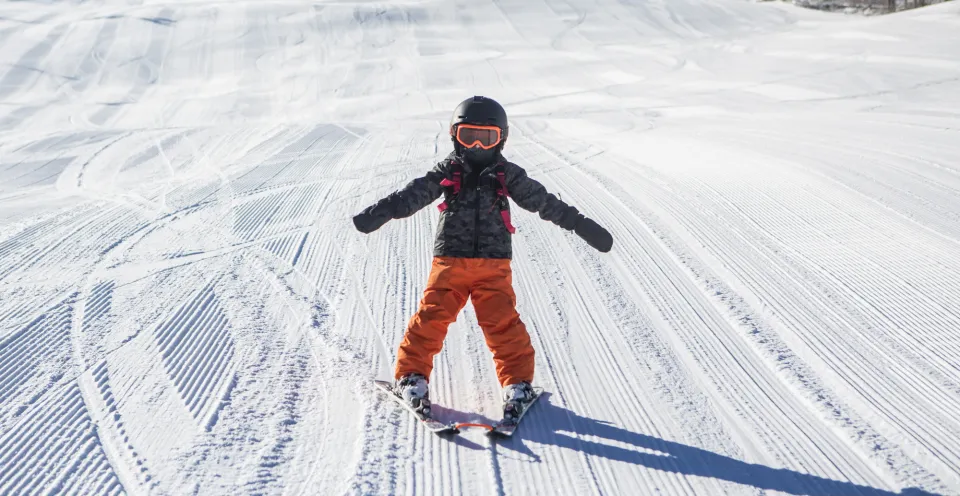 A child downhill skiing.