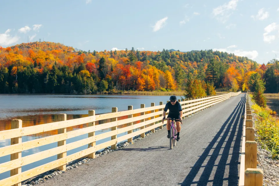 Biking on the Adirondack Rail Trail in the fall.